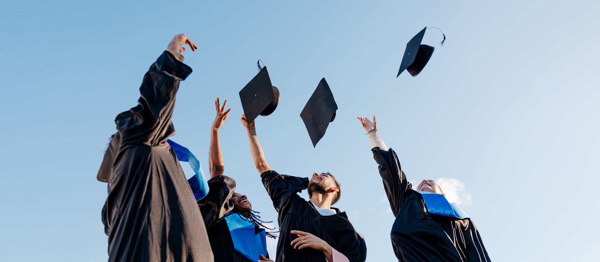 Graduates throwing caps