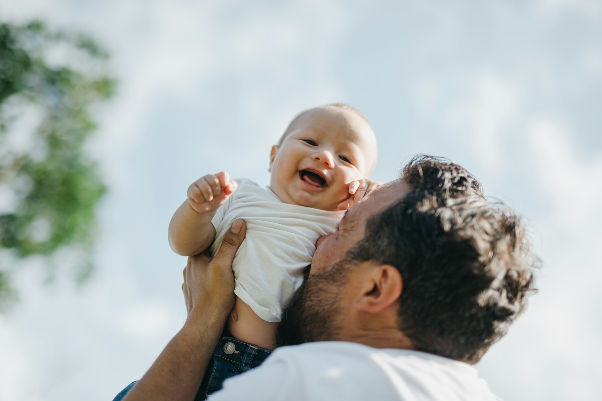 Father and giggling baby
