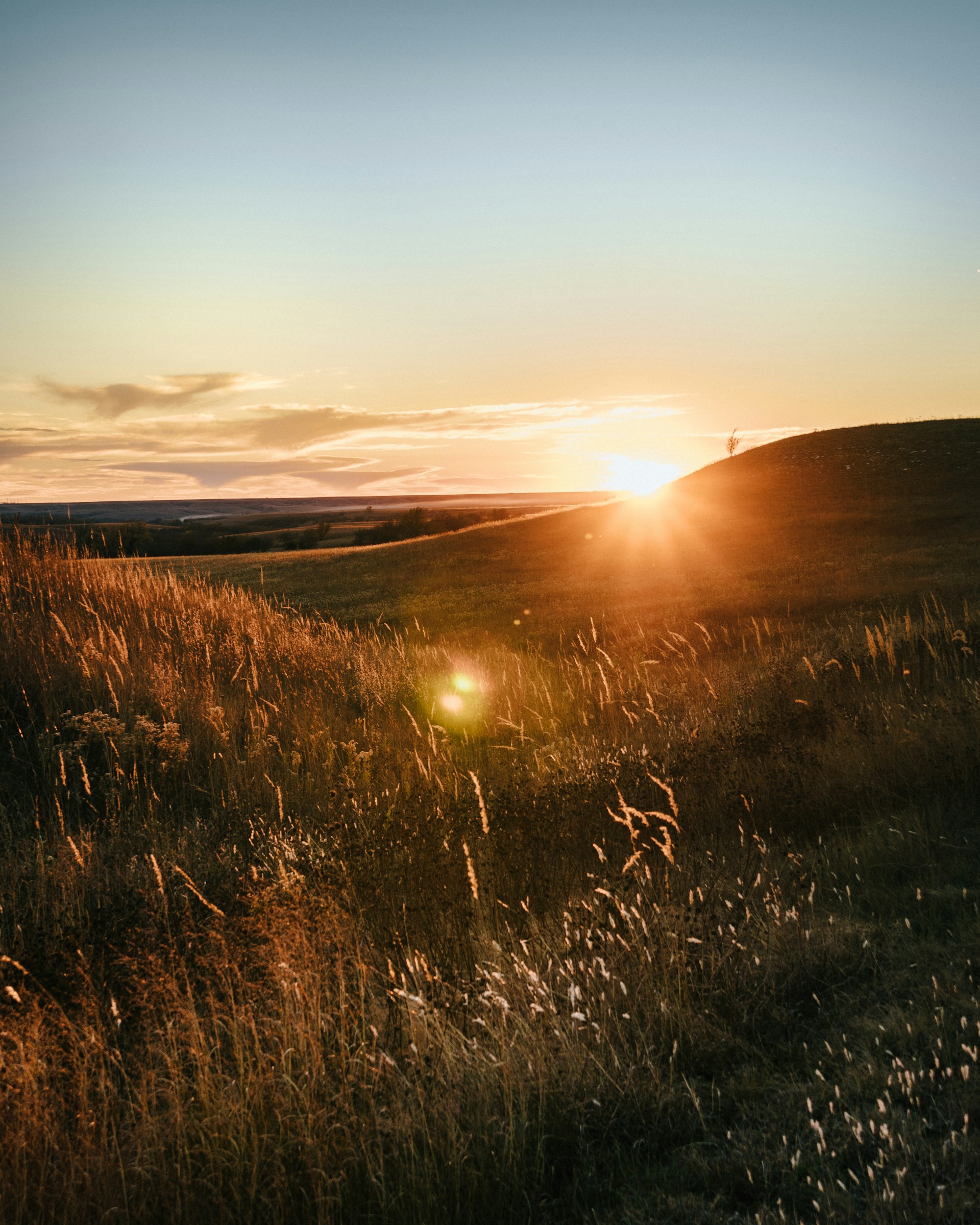 A sunset over rolling hills